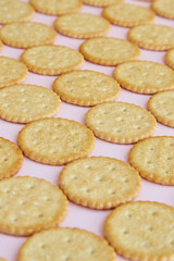 Salty crackers on a pink background close-up, cookies on a pink background, fresh cookies