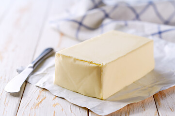 fresh butter and knife on a kitchen table, selective focus.