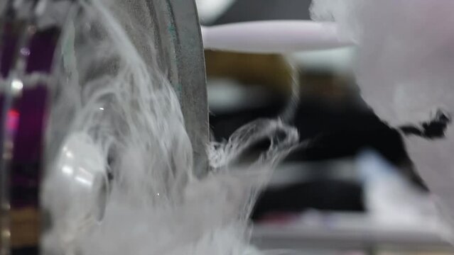 Cotton candy. A man makes cotton candy for children. Manually rolling out cotton candy in a cotton candy machine. Making candy floss