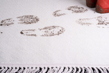 Muddy carpet. Dirty footprints in wet mud, red shoes isolated on background. dirty stains in daily life for cleaning concept.