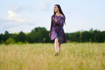 Gorgeous hispanic young woman on a meadow with oak forest