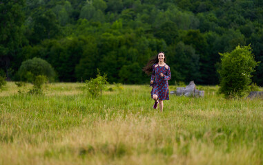 Naklejka premium Gorgeous hispanic young woman on a meadow with oak forest