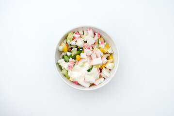 Vegetable salad with meat and sauce in a white salad bowl. A small snack.
