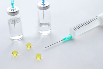 syringe and pills on  table