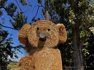 A bear figurine made from rolls of straw for the fun and joy of children and their parents