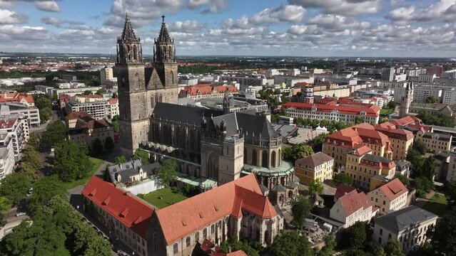 Close flight in a semicircle around Magdeburg Cathedral. In the background the old town of Magdeburg. In the distance the districts of Stadtfeld and Olvenstedt. Travel Destination in Saxony-Anhalt