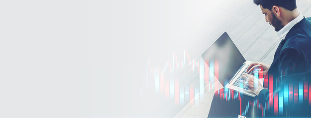 Businessman Analyzing Stock Market Trends on Laptop with Graph Overlay. Professional investment, experience economy, Finance and Business Technology Concept.