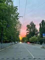 Pink sunset against the backdrop of mountains, roads