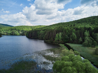 Obraz premium Lake Trei Ape Three Waters photographed from a drone flight. The blue sky with clouds and green forests.