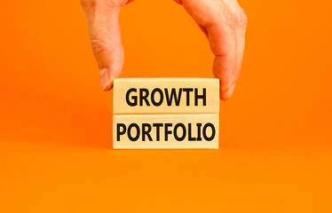 Growth portfolio symbol. Concept words Growth portfolio on beautiful wooden block. Beautiful orange paper background. Businessman hand. Business Growth portfolio concept. Copy space.