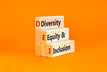 DEI diversity equity and inclusion symbol. Concept words DEI diversity equity and inclusion on blocks. Beautiful orange background. Business DEI diversity equity and inclusion concept. Copy space.