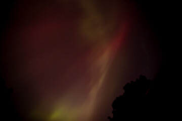 Pink northern lights appear in the night sky over Iowa. 