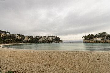 Fototapeta premium Tranquil Cala Galdana Beach with Coastal Cliffs, Menorca