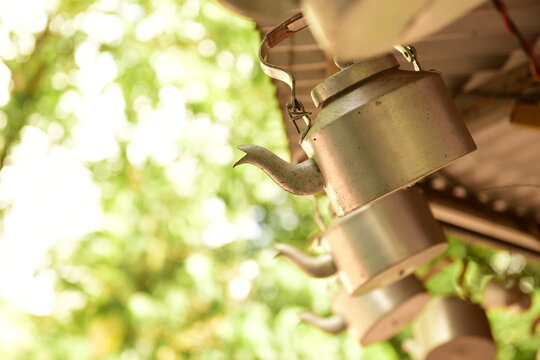 Tea kettles hanging outside a tea shop in India as a decorative signage to attract customers