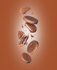 Levitation of chocolate crispy cookies in the air on a brown background