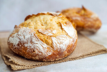 Freshly baked round bread . Close up