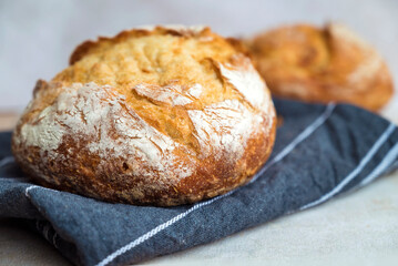 Freshly baked round bread . Close up