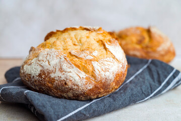Freshly baked round bread . Close up
