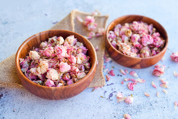 Flower tea rose buds in wooden bowl