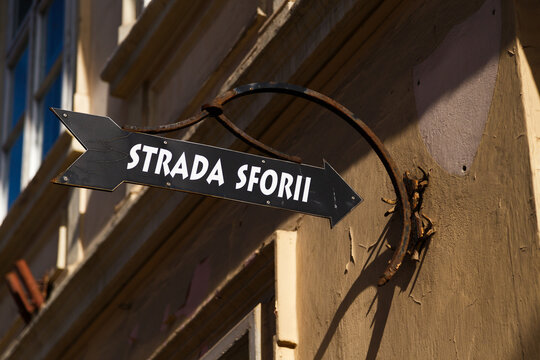 A direction sign for tourists to The Strada Sforii or Rope Street, narrowest street in the city of Brasov, Romania.