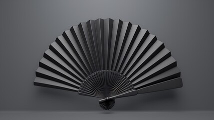 A black hand fan is opened against a black background. The fan is made of paper or fabric and has a delicate appearance.