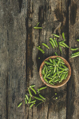 Green Peas. Green background. Green pea top view copy space. Fresh organic green peas. Vegetable harvesting. Beautiful close up of fresh peas and pea pods. Healthy vegetarian food