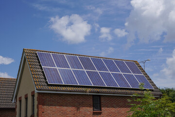 Naklejka premium solar panels installed on roof of residential property. photovoltaic solar cells on rooftop. power and eco energy source 