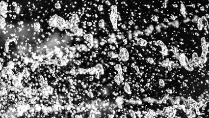 Flying water drops on black background