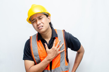 a construction worker groaned in pain while holding his chest. overworked concept illustrated by...