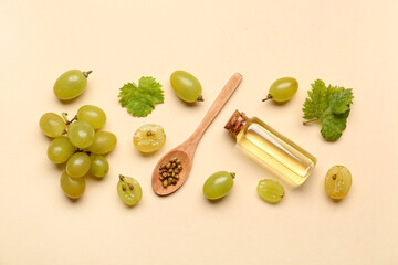 Beautiful composition with ripe white grapes and essential oil on color background