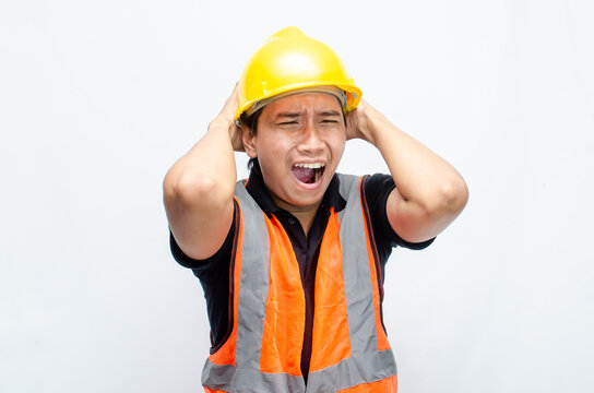 stressed overworked concept illustrated by asian male construction worker in orange vest and yellow safety helmet with furious, mad, sad, angry expression. 