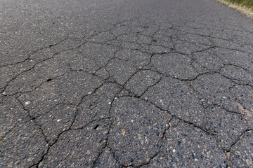 Obraz premium a part of a highway covered with cracked asphalt