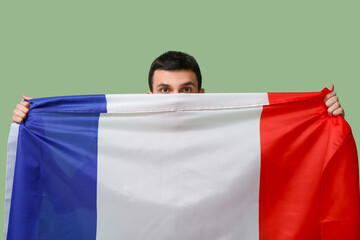 Young man with flag of France on green background