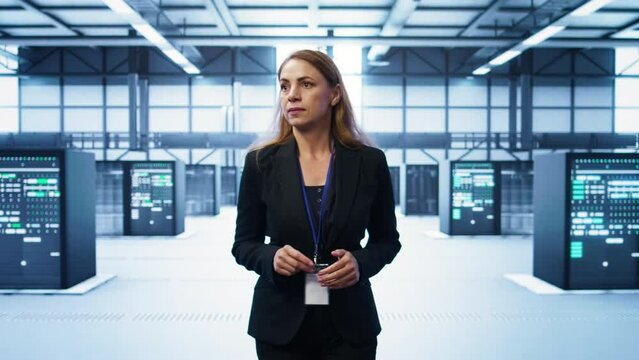 Admin walking in data center, monitoring systems to identify root cause of errors. IT specialist in server farm establishment doing diagnosis, looking for equipment bugs in need of repairing, camera B