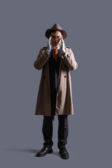 Male spy in gloves on dark background