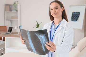 Female doctor studying x-ray image of lungs at hospital