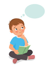 Cute little boy thinking dreaming while reading book sitting on floor