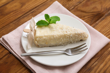 Plate with tasty cheesecake pop on wooden background