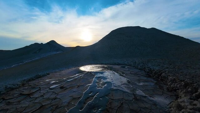 Mud volcano. Always active mud volcanoes surrounded by mountains