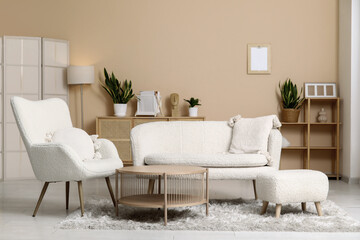 Interior of stylish living room with white sofa, armchair and wooden table