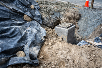 New storm water sewar installation in progress, new cement pore with rectangular iron grate on top,...