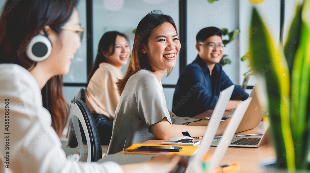 Poster Colleagues in a modern office collaborate on a project Business professionals use laptops at a table The diverse teams happy smiles showcase teamwork Perfect for startups and entrepren : Generative AI