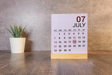 White calendar cubes with date july 18 on yellow background. Creative layout.