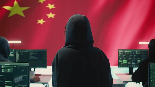 Terrorist person in a Chinese cyber security room hacking national systems, reading fake news and hybrid warfare propaganda. Digital mercenary group spread misinformation and falsification. Camera B.