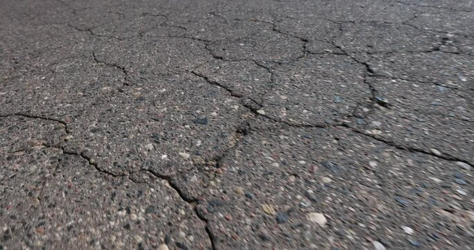 details asphalting of a road , a part of a highway covered with cracked asphalt