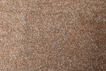 Shiny light brown glitter as background, closeup