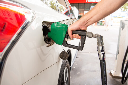 pumping petrol at a servo in the day time
