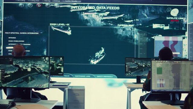 Army personnel applying national safety protocols by verifying all ships anchoring in the coastal ports, using radar surveillance on big screen in military command post. Federal operations. Camera B.