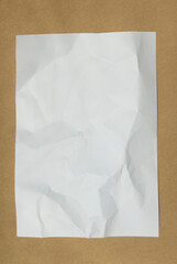 
Crumpled paper lying on a brown background.