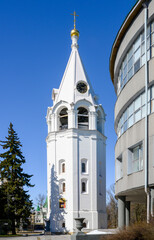 The bell tower of the Transfiguration Cathedral and a fragment of a modern building on the territory of the ancient Kremlin in Nizhny Novgorod